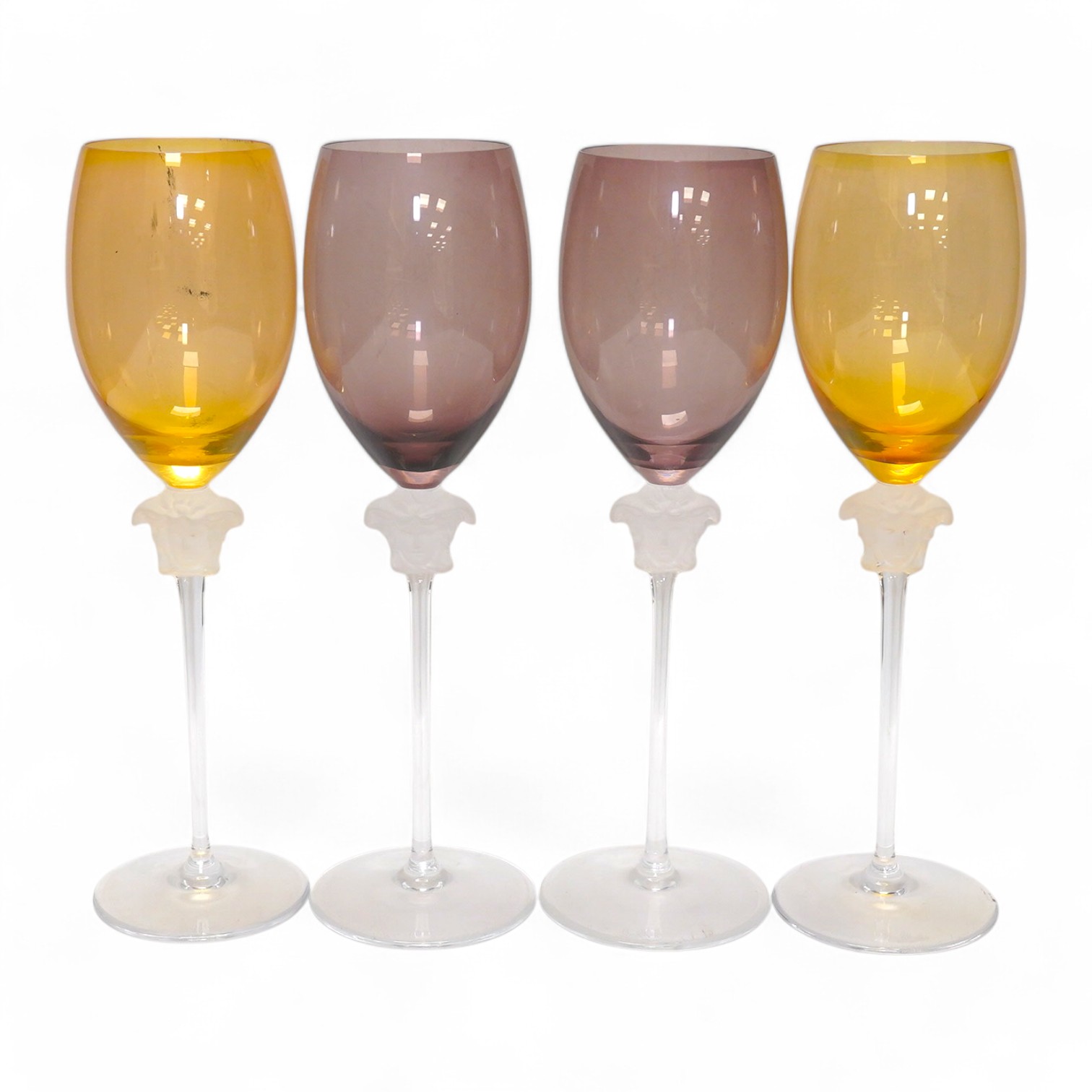 Four boxed Rosenthal for Versace Medusa head wine glasses in various colours, 26cm high. Condition - good.